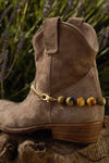 Buff cowboy boot with fancy tiger's eye spur with brass chain