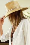 Woman wearing white pearl hat band
