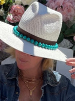 Straw hat featuring the turquoise hat band